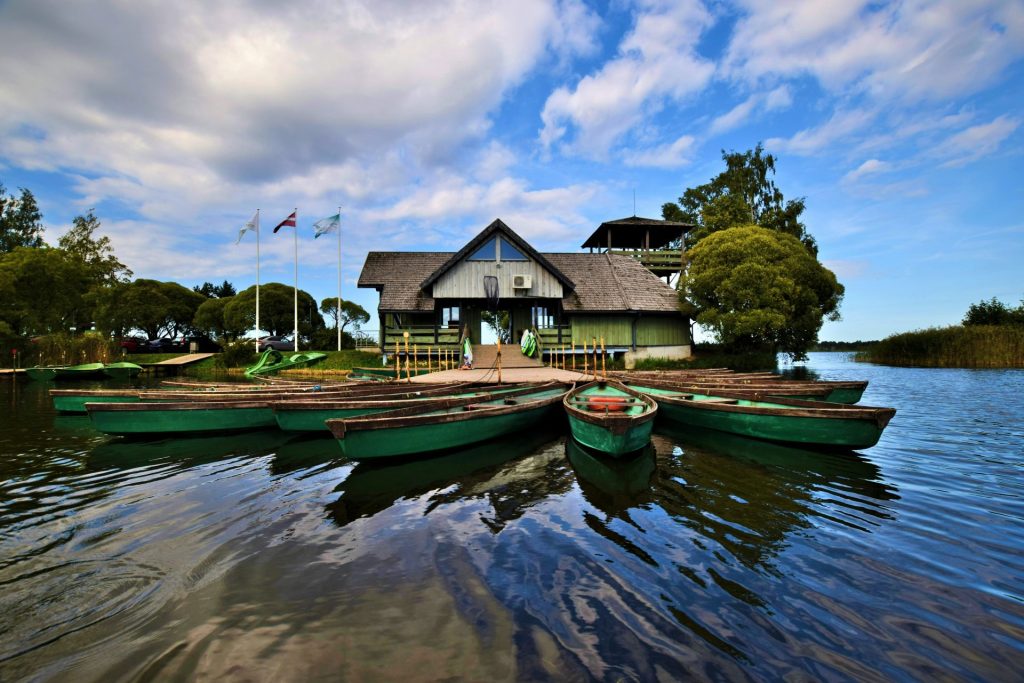 canoes docked in front of white and green house