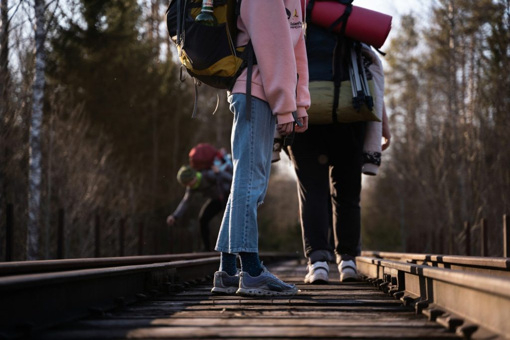a couple of people walking across a bridge