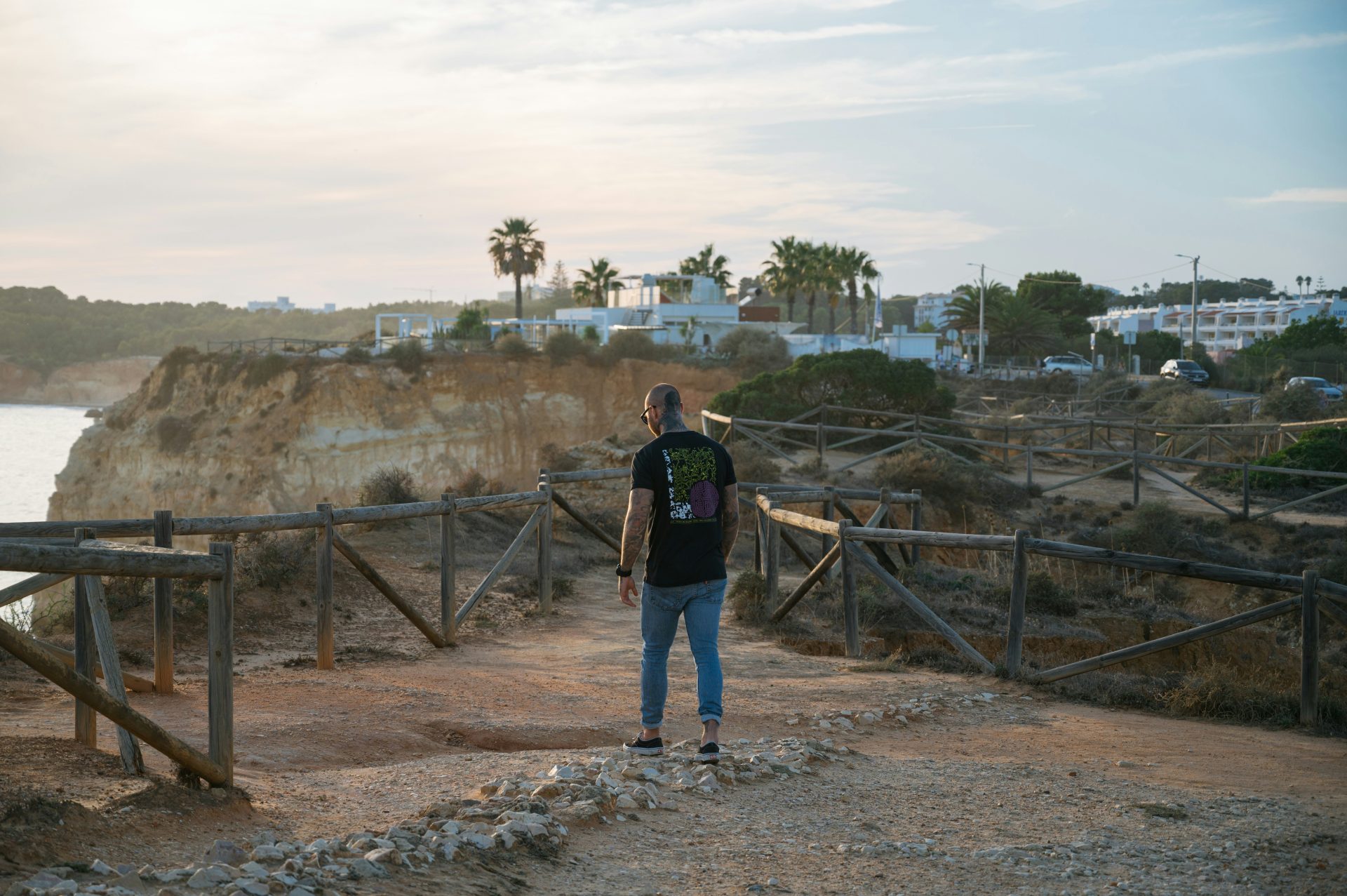 a man standing on a path near a body of water